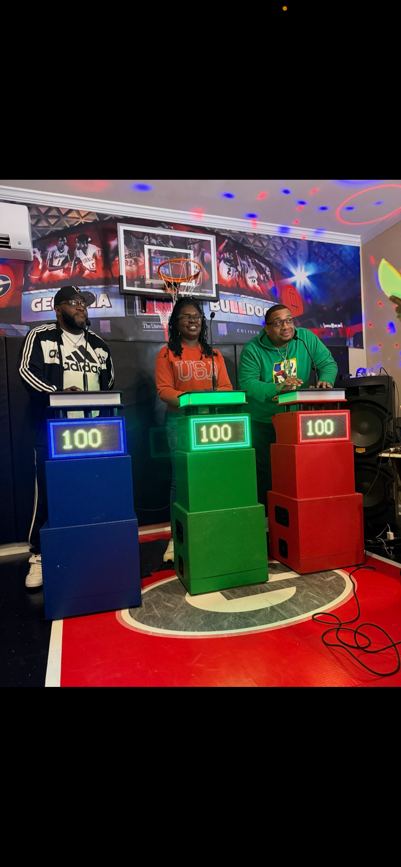 Three contestants at lit-up scoring podiums during a Black In The Day Trivia game show